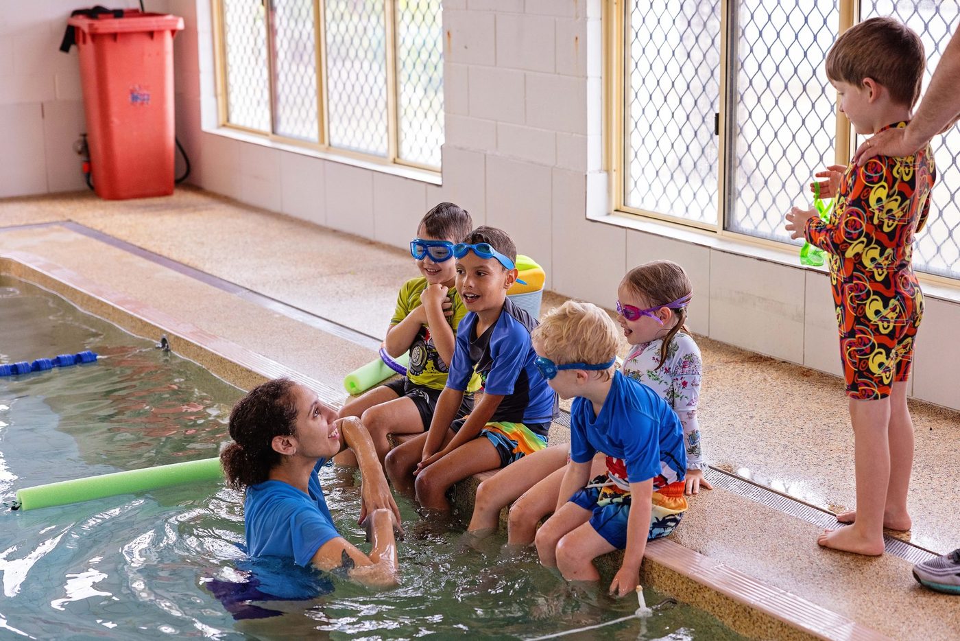 Instructor gently guiding a child through the water