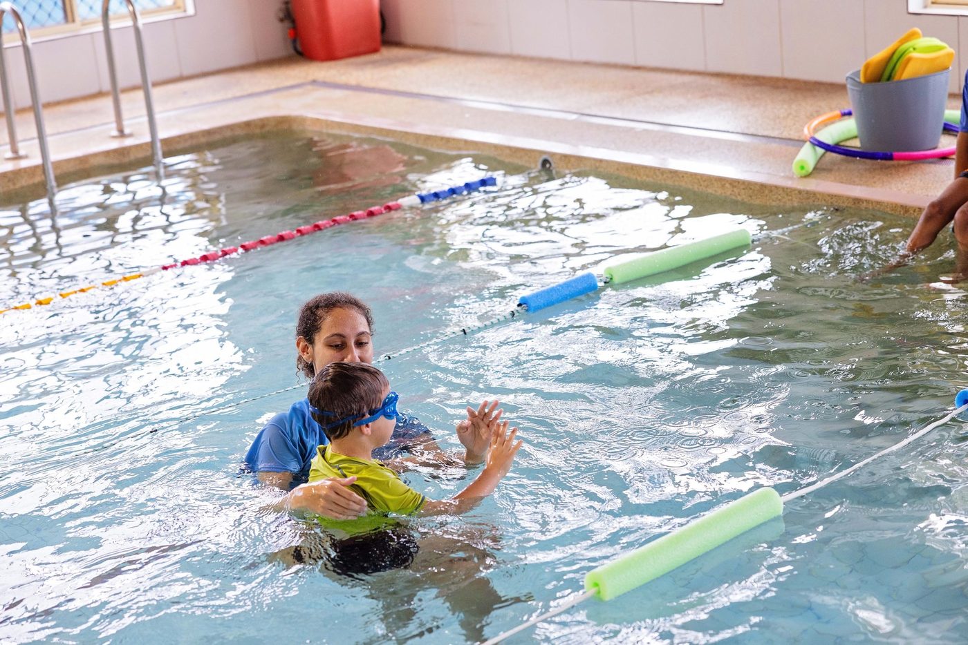 Instructor teaching an infant to swim
