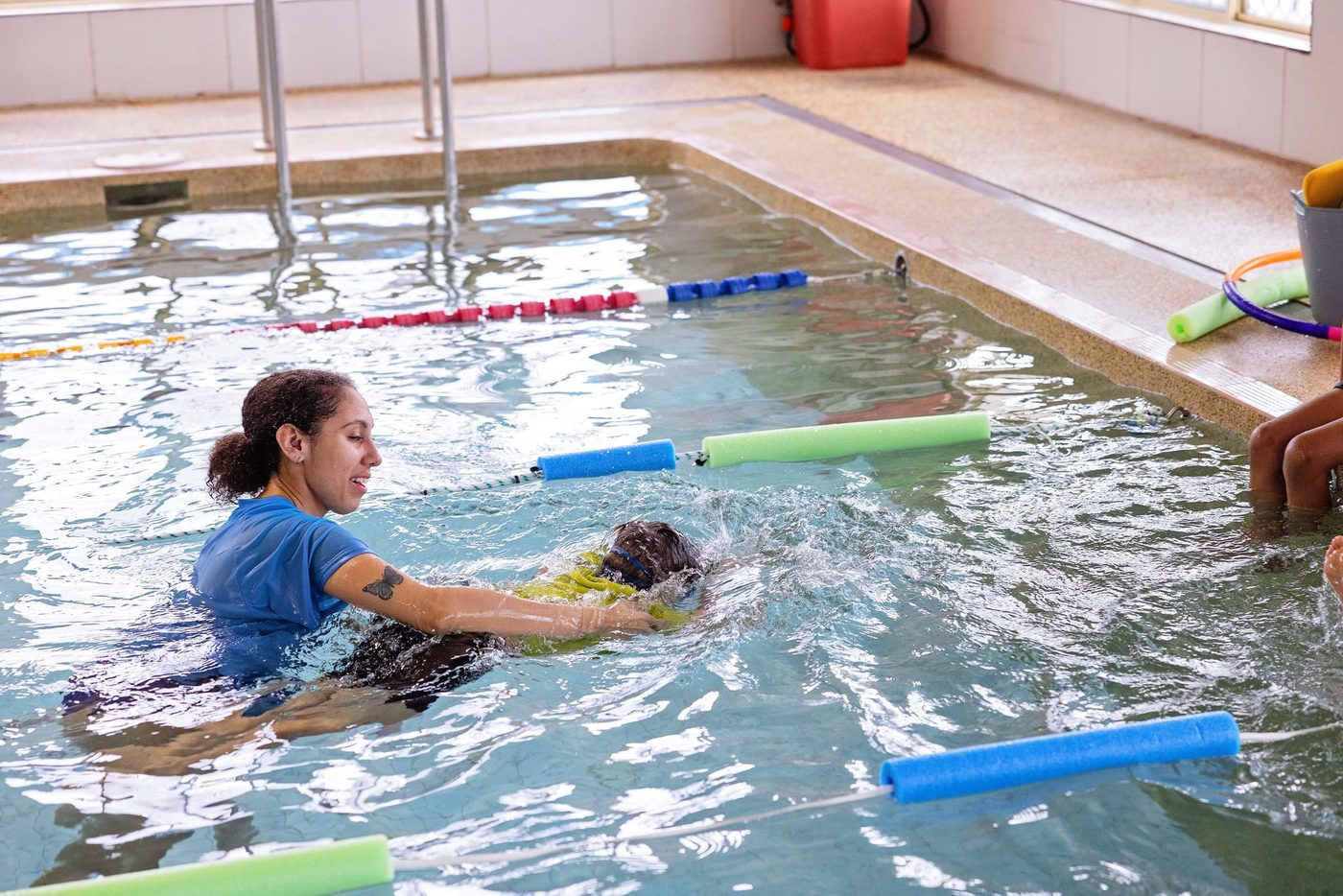 Group of children on the pool edge with their instructor