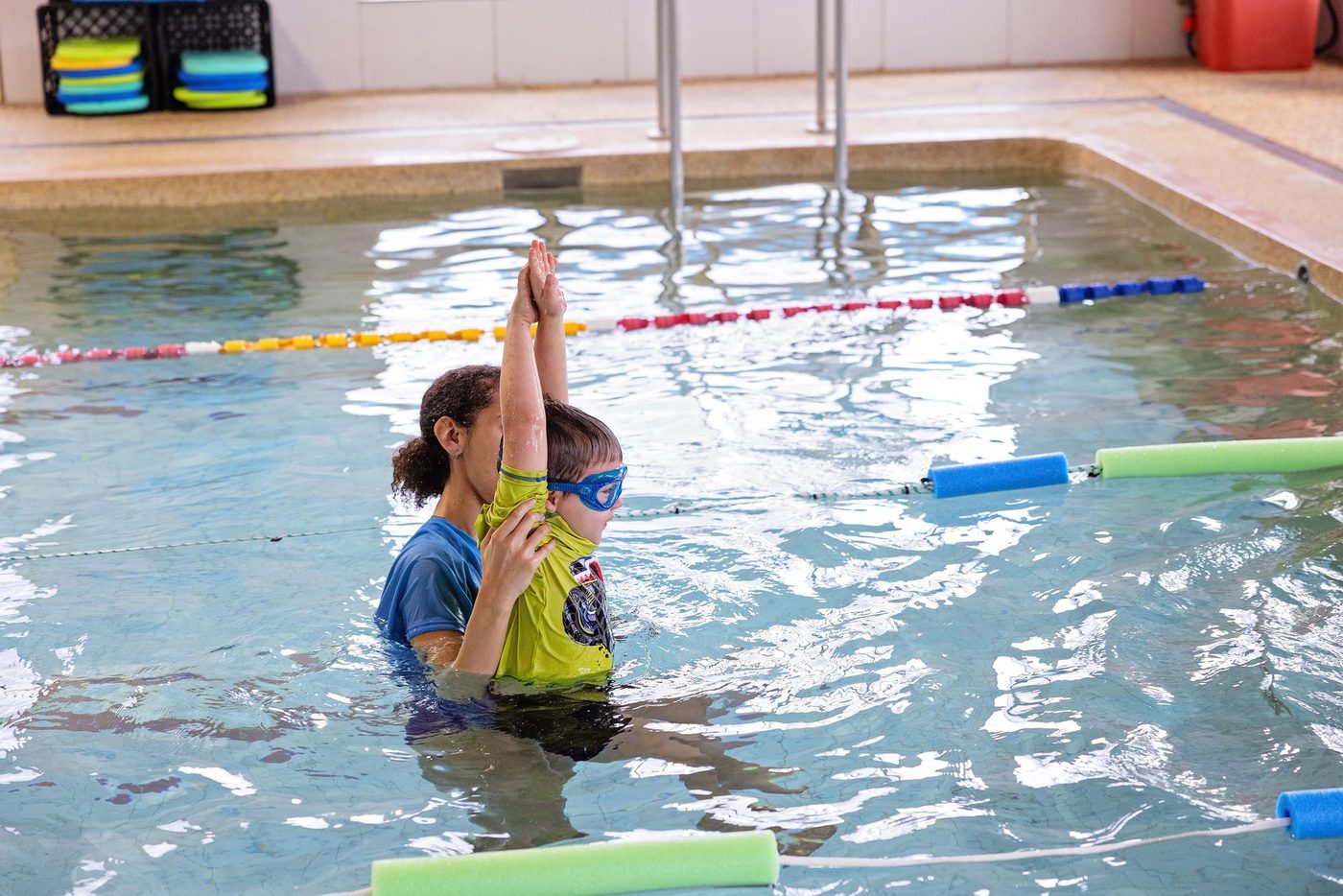 Children high-fiving their swim instructor