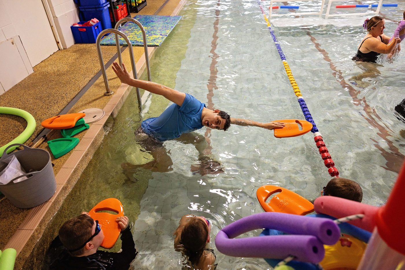 Young swimmer practising strokes in a lane